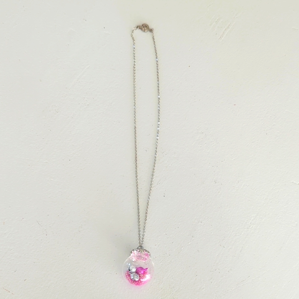 Silver Necklace with Pink and silver mini jingle bells in a glass globe Pendant